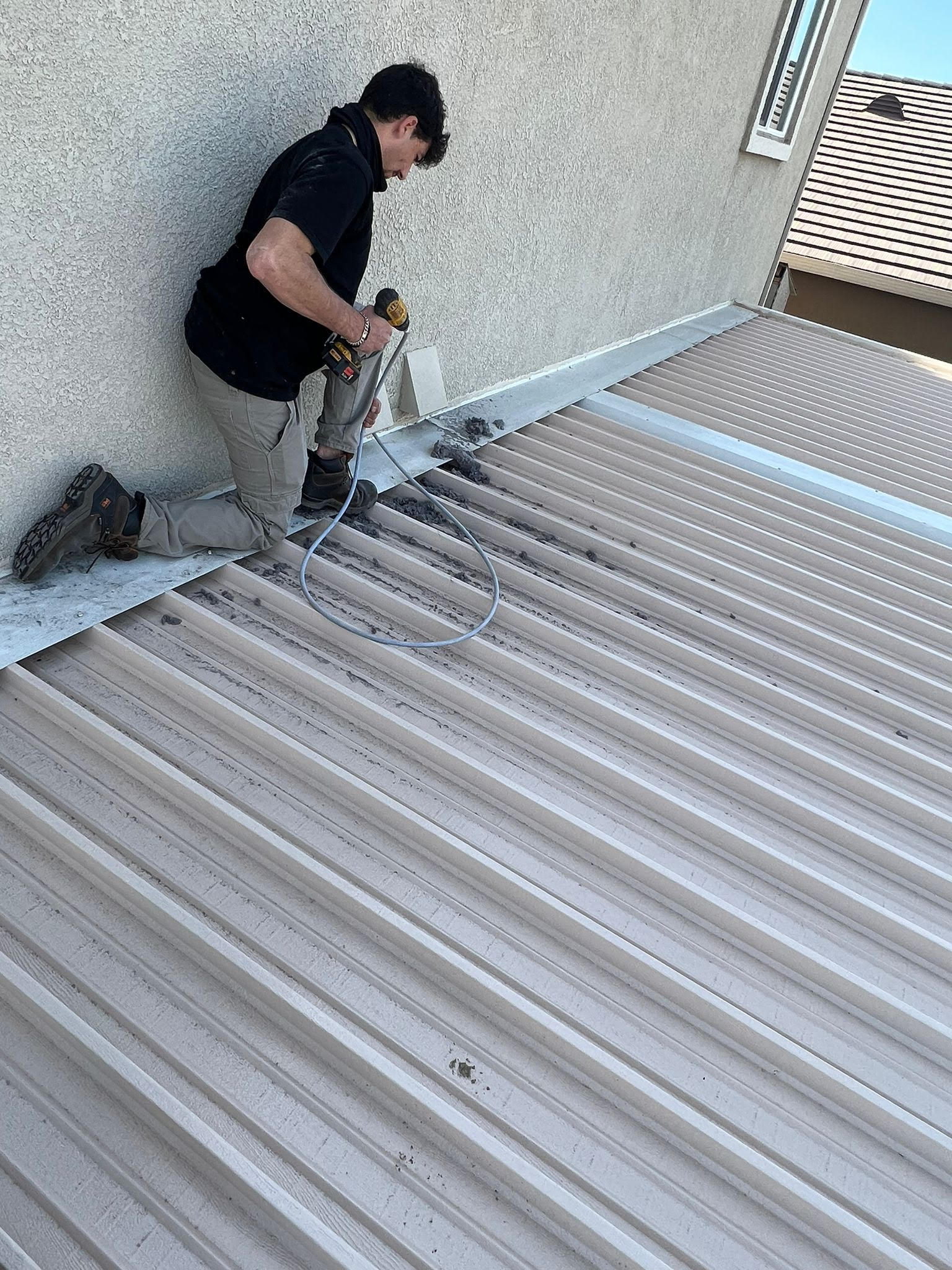 Technician performing dryer vent cleaning